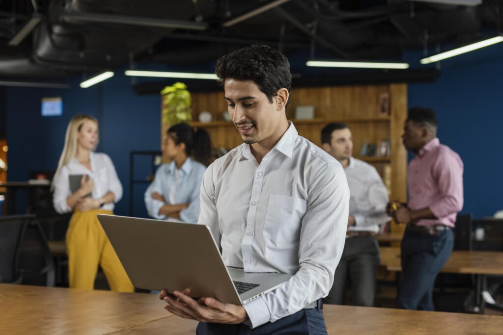 smiley man work holding laptop